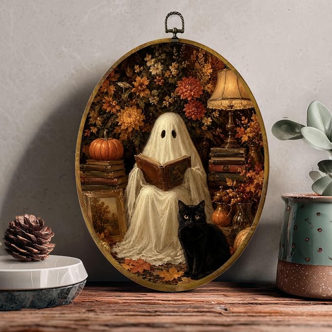 Reading Ghost Black Cat Oval Wall Art, Framed Canvas Decor, 8.5x11.5 Inch | Reading ghost with black cat, pumpkins, autumn flowers and cozy lamp decor