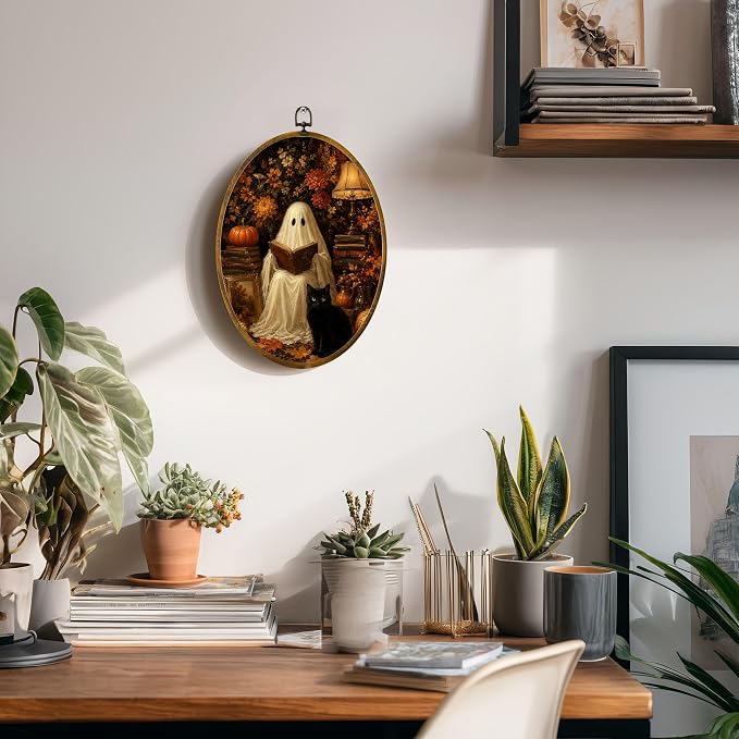 Reading Ghost Black Cat Oval Wall Art, Framed Canvas Decor, 8.5x11.5 Inch | Reading ghost with black cat, pumpkins, autumn flowers and cozy lamp decor